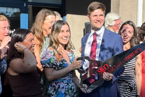 group photo of people celebrating The Schwaegerle Real Estate Team in San Luis Obispo, Ca with a ribbon cutting.
